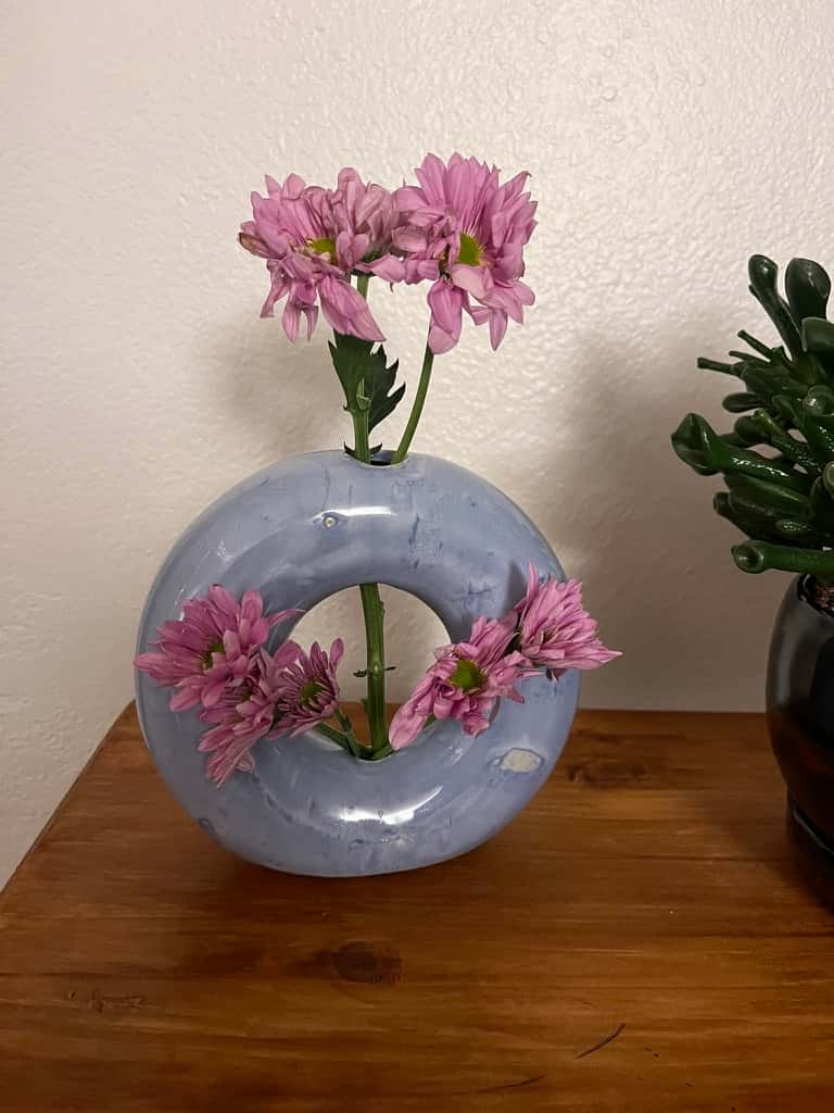 A donut-shaped vase.