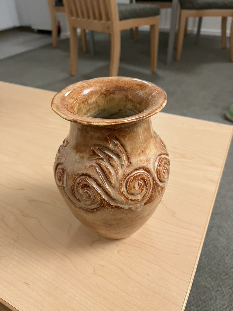 A carved vase.