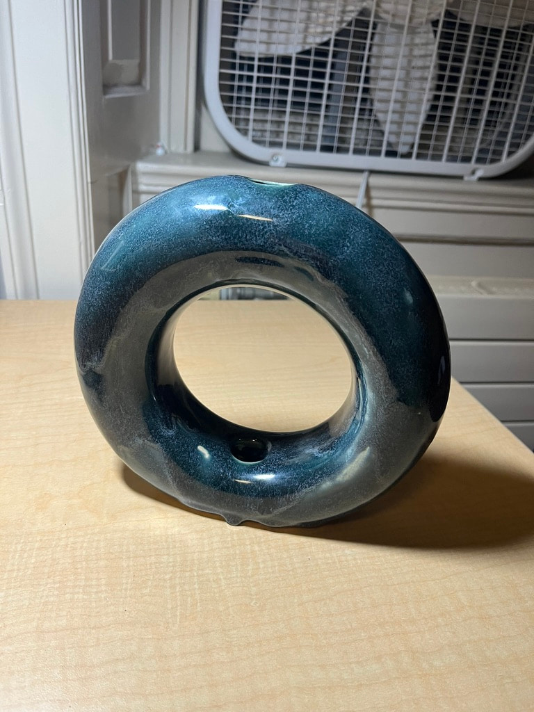 A dark blue donut vase.