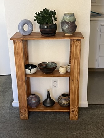 A shelf with pottery.