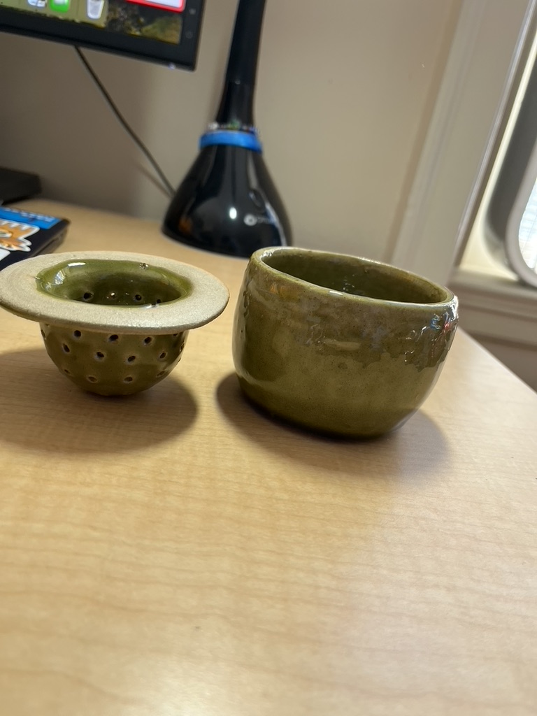 A teacup and strainer.