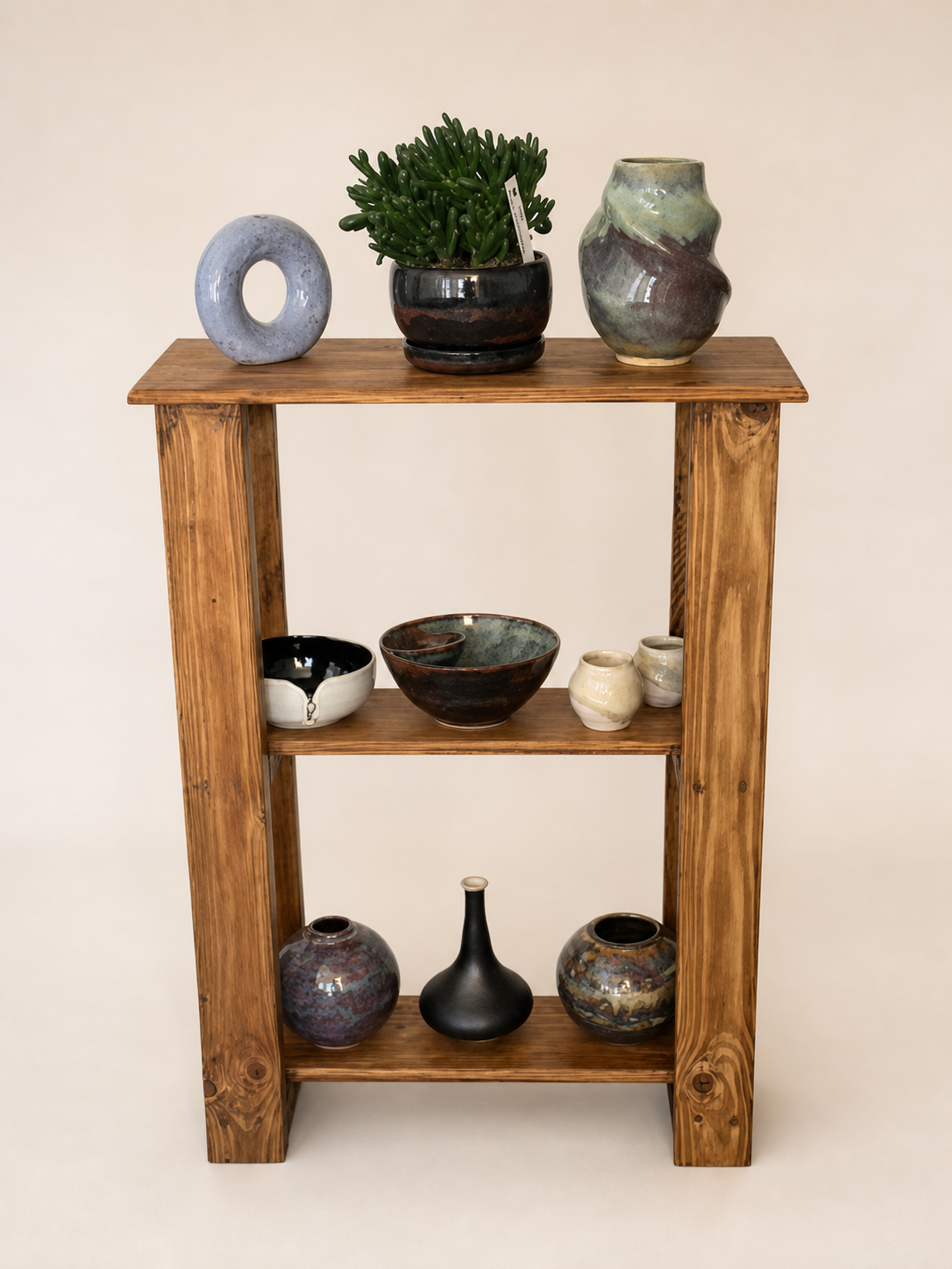 A shelf with pottery.