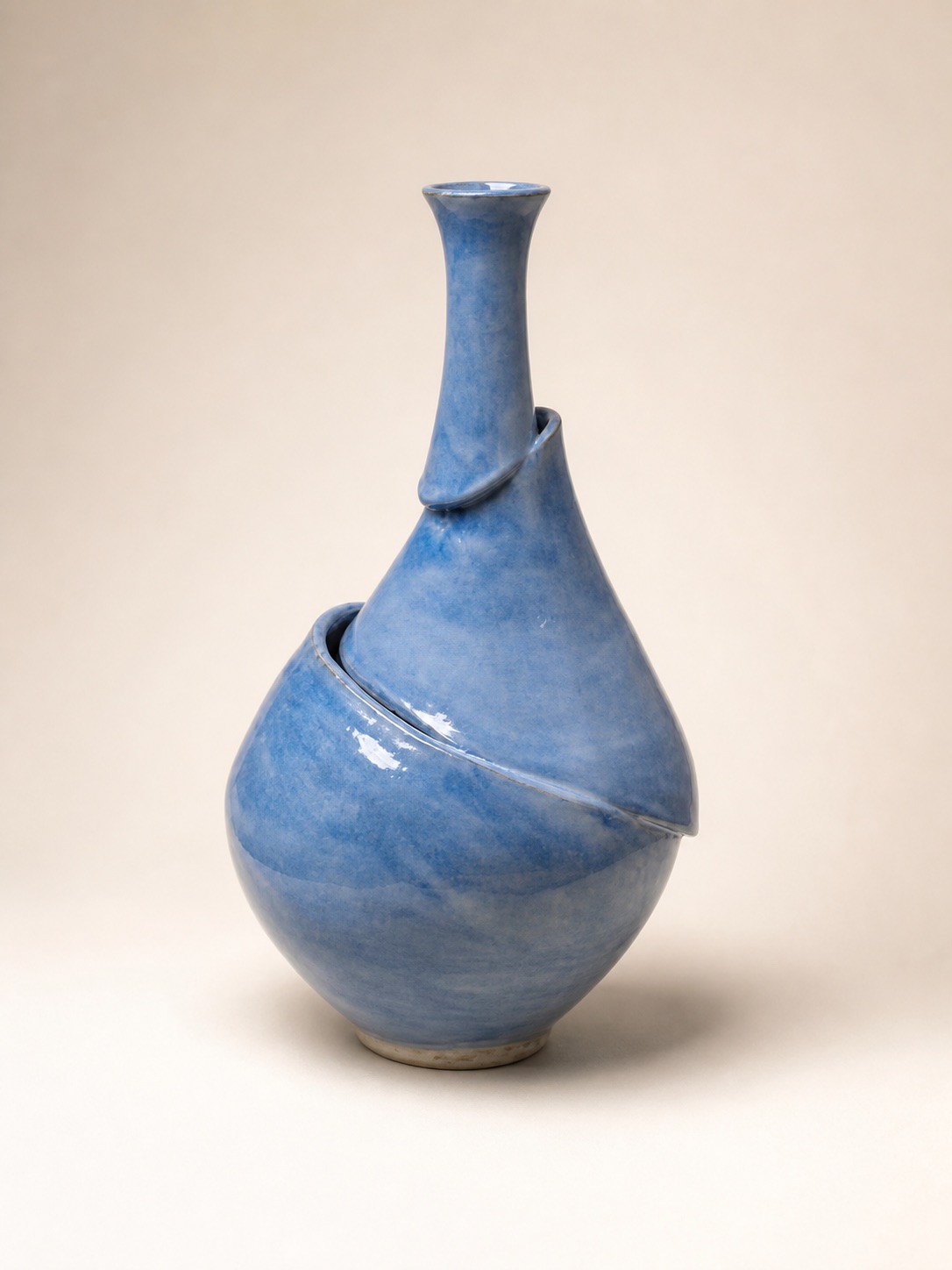 A tall blue altered vessel with an overlapping split form.