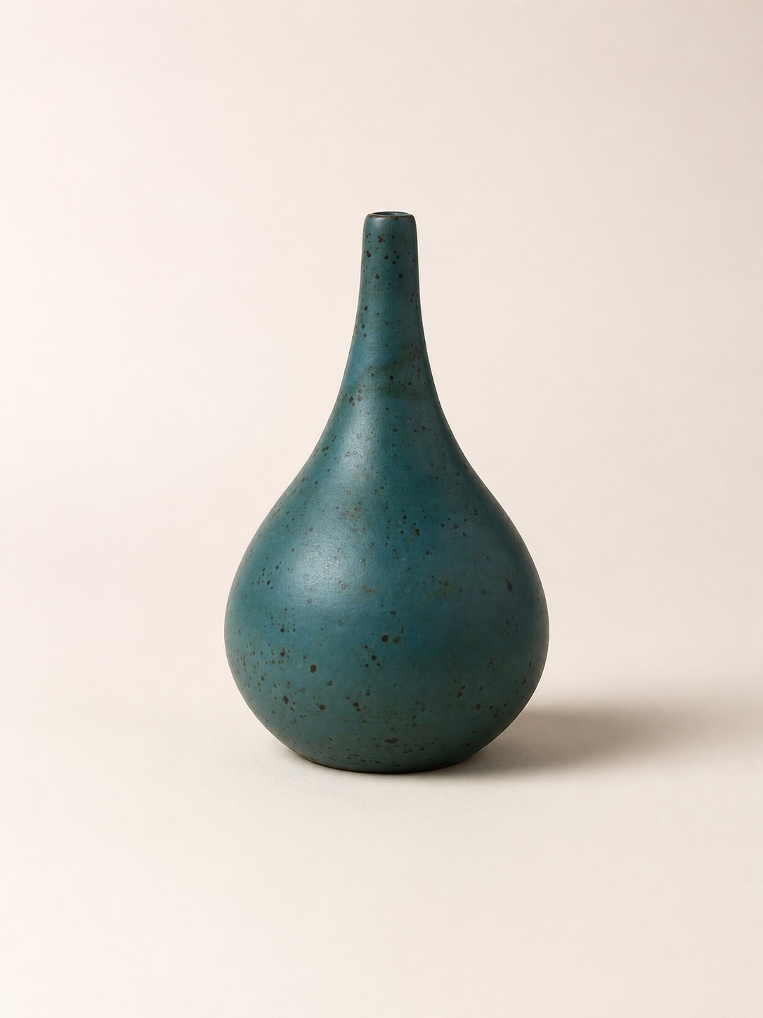 A matte teal bottle with a long narrow neck.